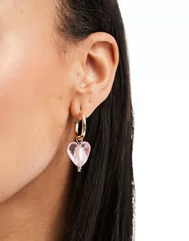 Petit Moments lexi huggie hoop earrings with pink heart pendant in gold | ASOS