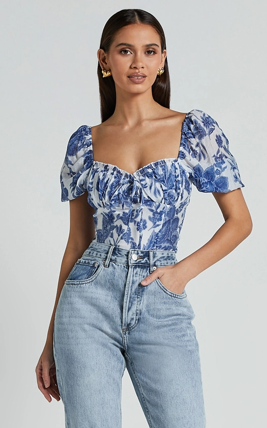 LIANA TOP - SHORT SLEEVE BUSTIER TOP IN WHITE AND BLUE FLORAL
