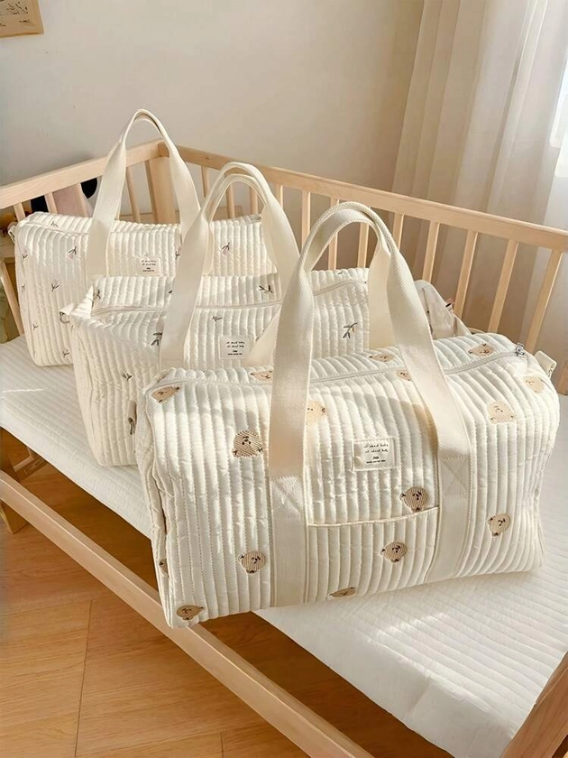 Un grand sac de maternité beige brodé de capacité, sac à bandoulière croisé pour l'extérieur