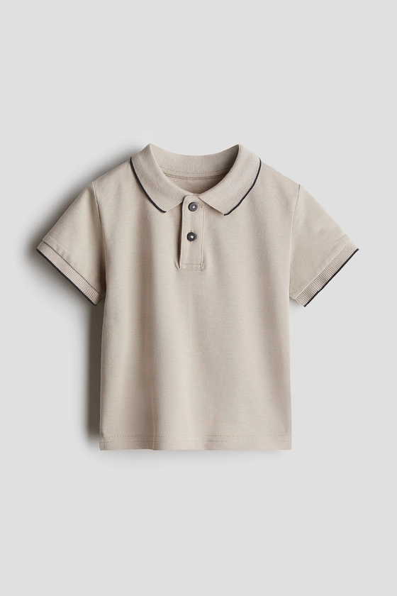 Cotton piqué polo shirt - Short sleeve - Regular length - Light beige - Kids | H&M GB