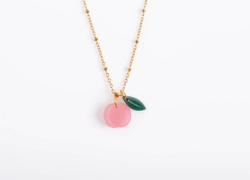 Necklace with peach and leaf pendant