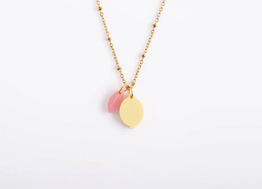 Necklace with pastel colored lemon and leaf pendant