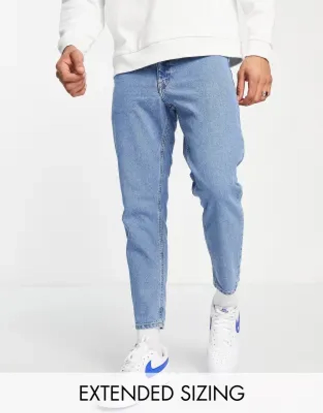 ASOS DESIGN tapered fit jeans in mid wash blue