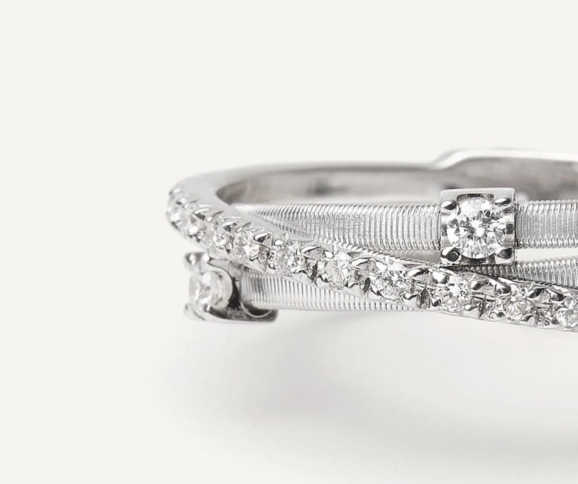 Three-band white gold ring with prong-set diamonds and a diamond-studd