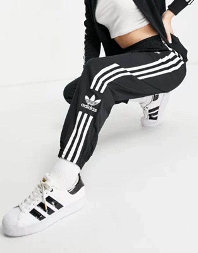 adidas Originals Lock Up three stripe track pants in black | ASOS