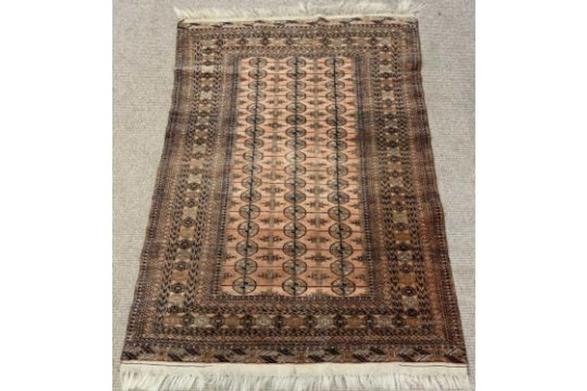 EASTERN RUG with repeating border and pattern, ground red and black, 188 x 125cms Provenance: Pr