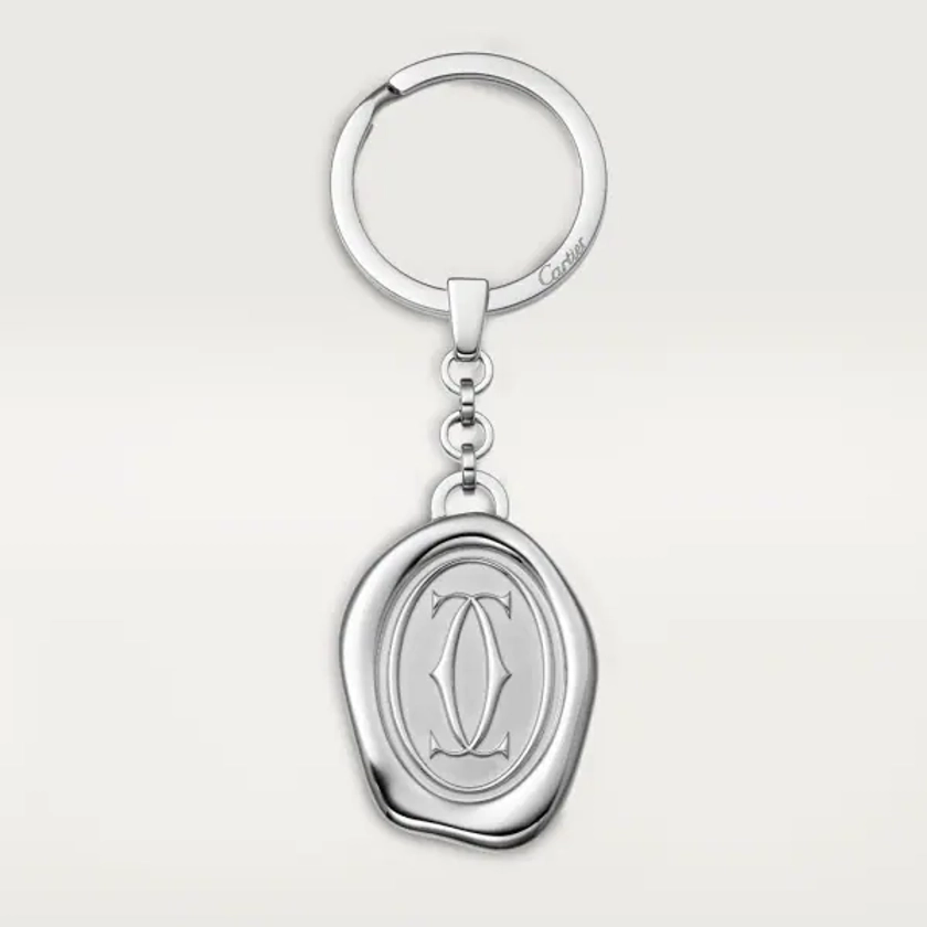 Key ring with wax seal décor: Stainless steel key ring with wax seal décor. Dimensions: 34.4mm high x 26 mm wide