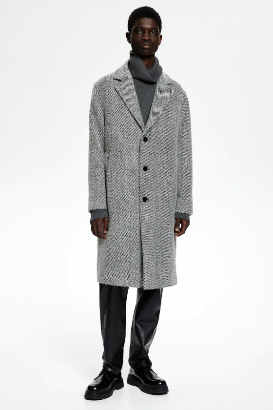 Manteau Loose Fit en laine mélangée - Encolure en V - Manches longues - Noir/motif blanc - HOMME | H&M FR