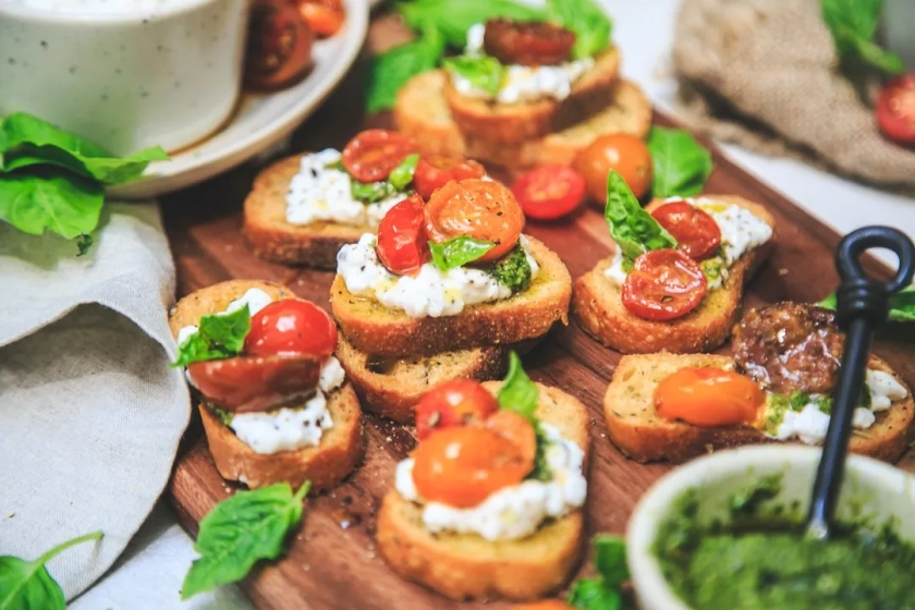 Cracked Pepper Cottage Cheese Crostinis with Basil Walnut Pesto & Garlicky Tomatoes - The Chutney Life