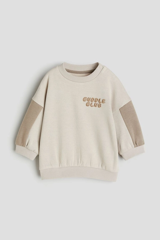 Cotton sweatshirt - Light beige/Cuddle Club - Kids | H&M GB