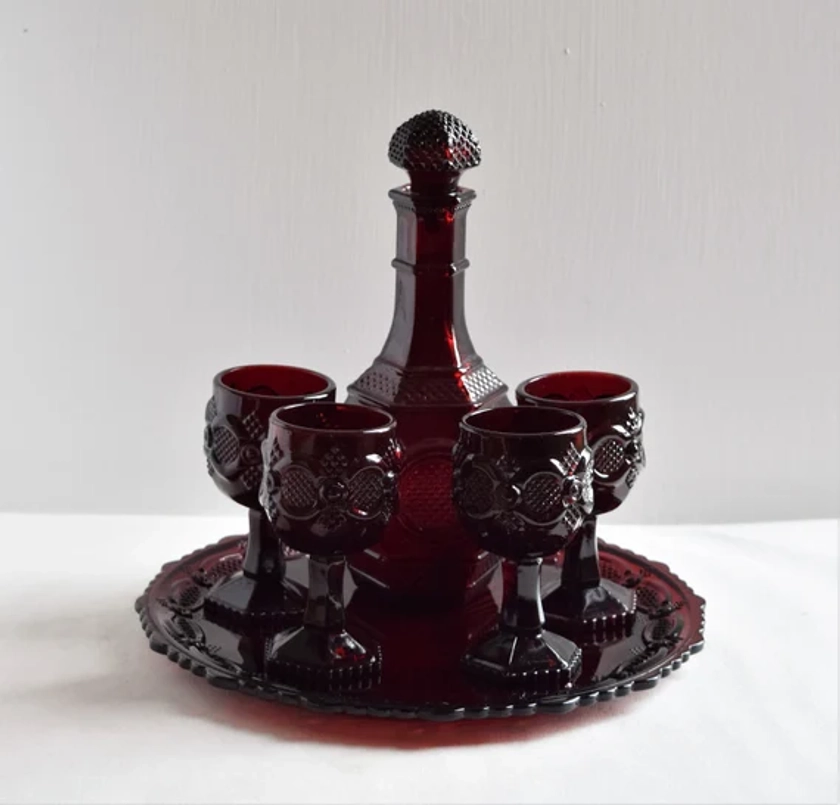 Avon Ruby Red Decanter Set On A Large Plate Wine Glasses Bottle