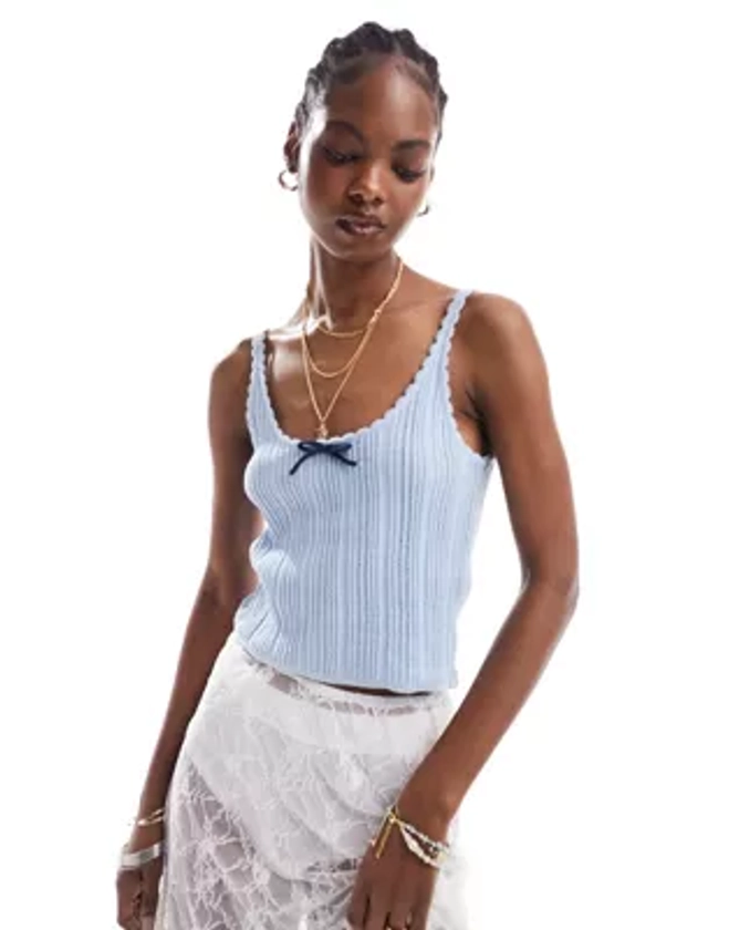 ASOS DESIGN knitted cami top in pointelle stitch with contrast bow detail in blue