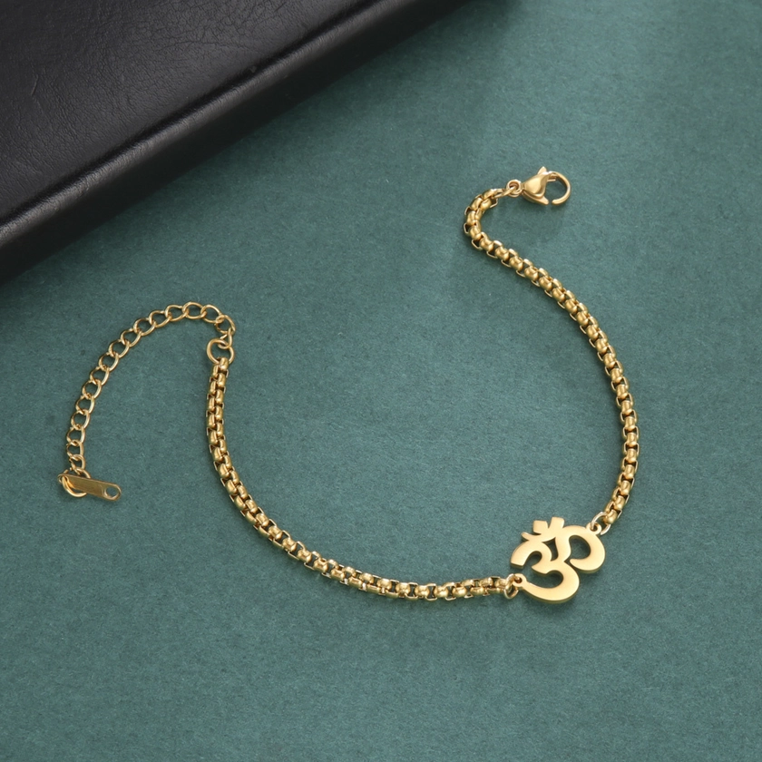 Bracelet with a stainless steel charm featuring the Hindu symbol OM, representing spiritual harmony and amulet for yoga enthusiasts.